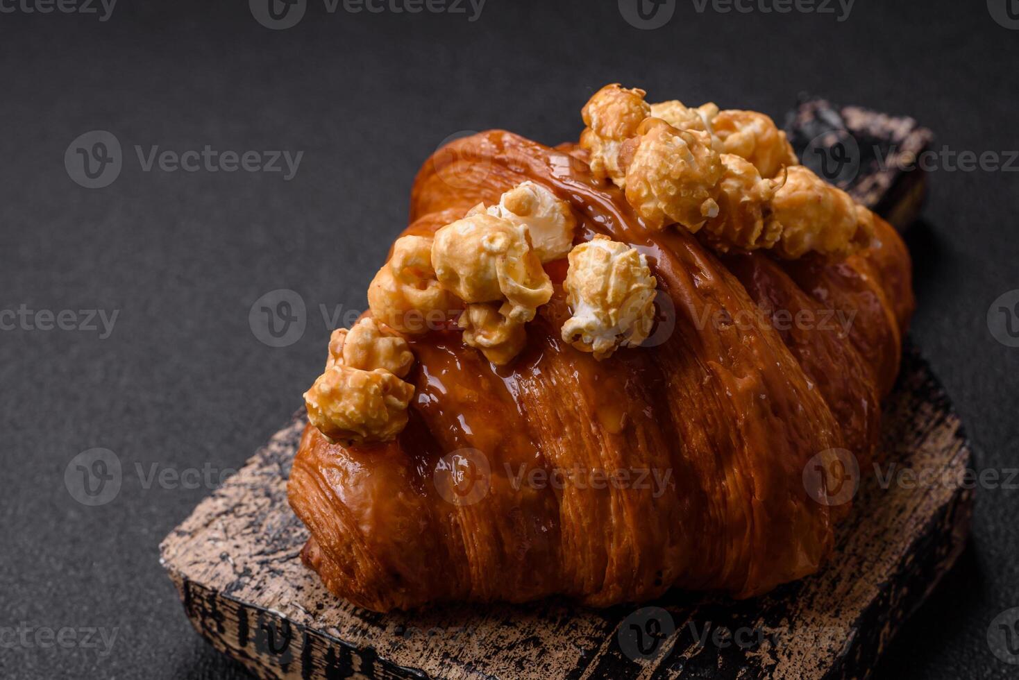 Sweet crispy croissant with salted caramel and glazed popcorn photo