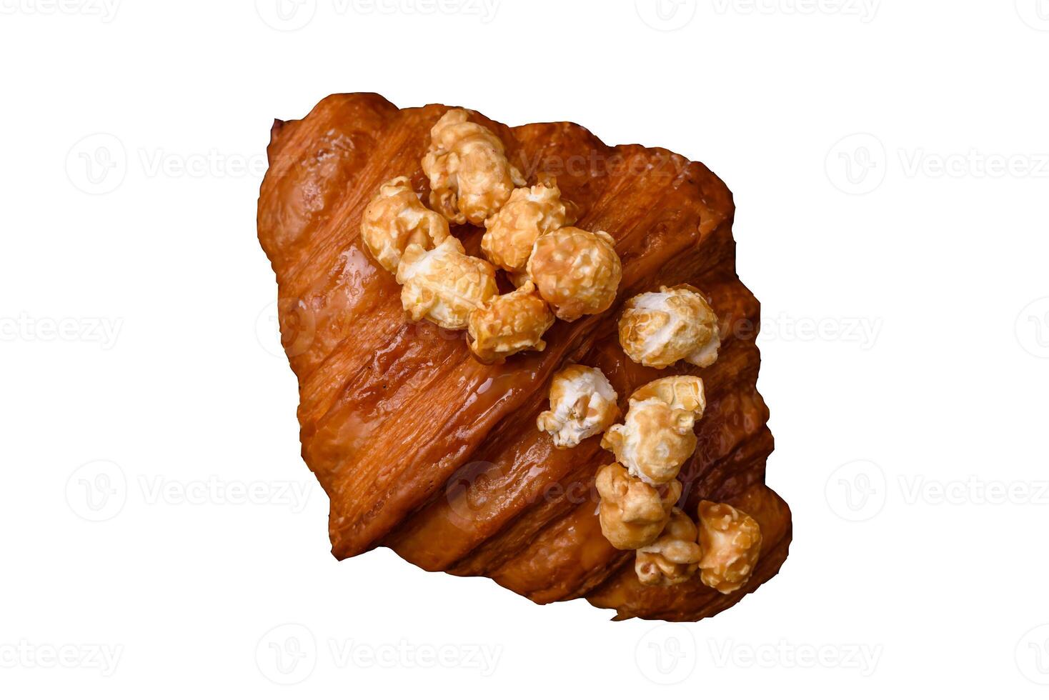 Sweet crispy croissant with salted caramel and glazed popcorn photo