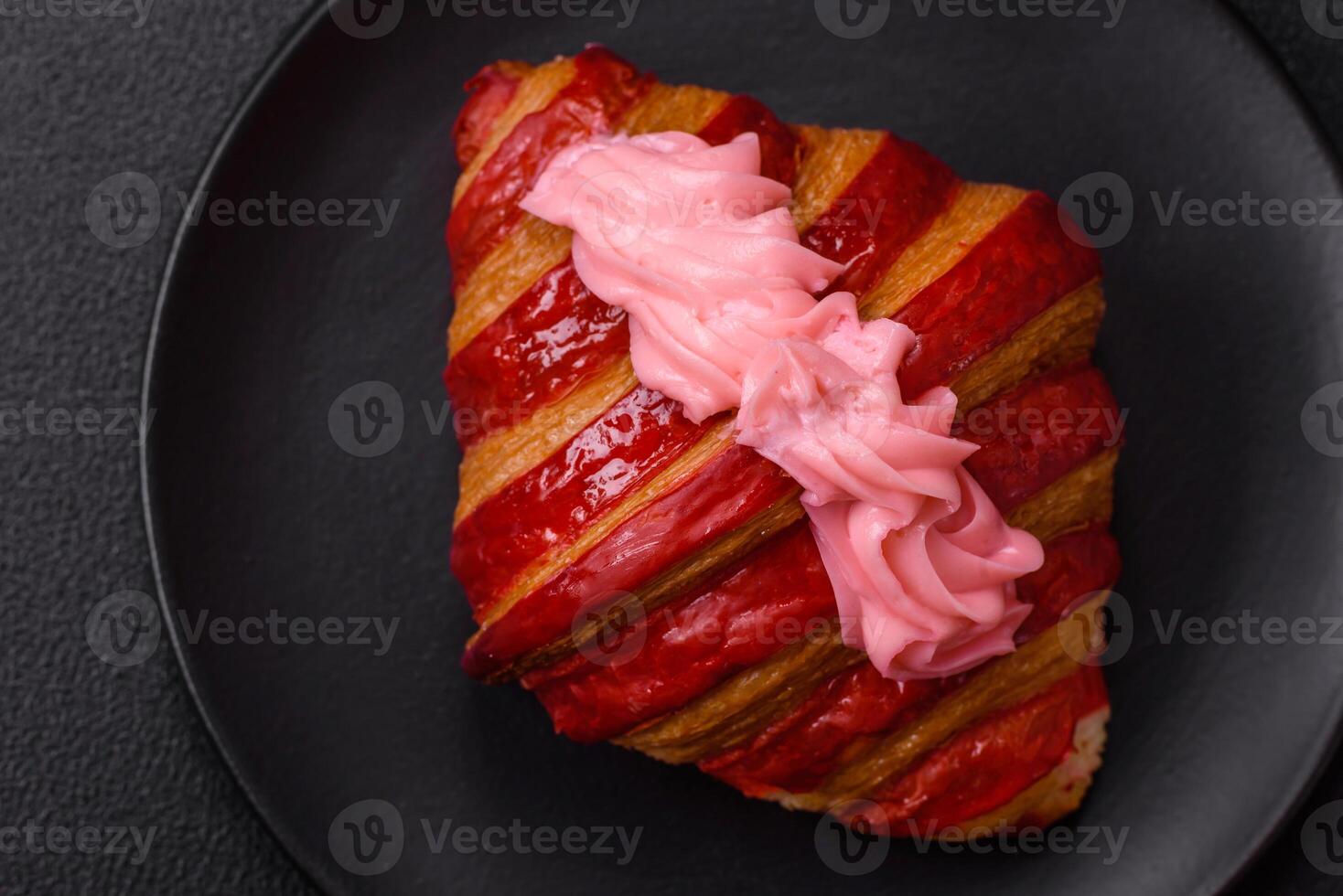 Crispy fresh red croissant with cream and strawberries photo