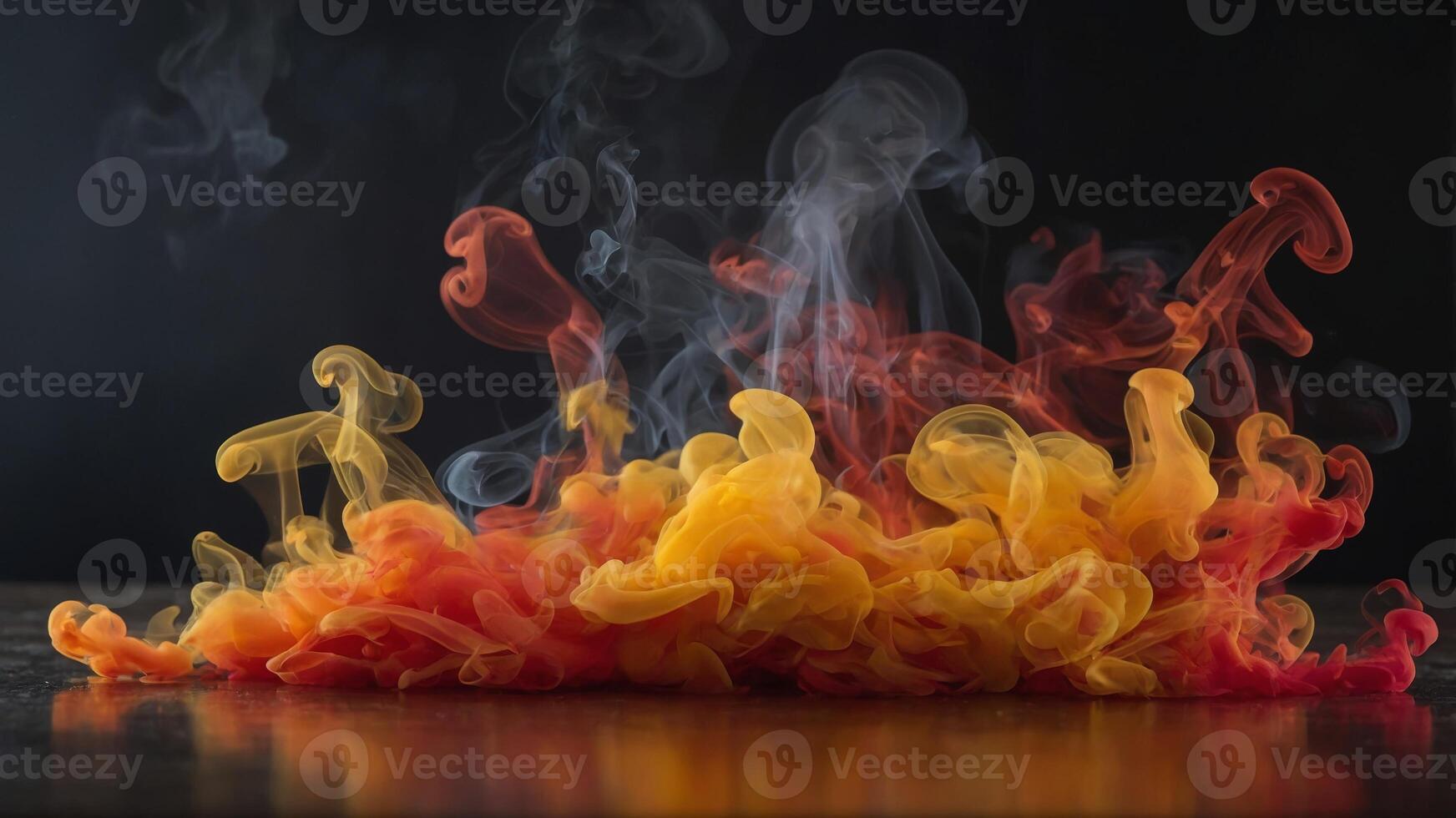 Fiery reds oranges and yellows blend together in this stunning display of colorful smoke. photo