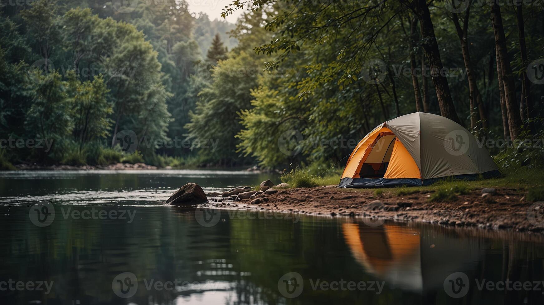 Camping tent by a serene river in a lush forest, peaceful nature escape concept. photo