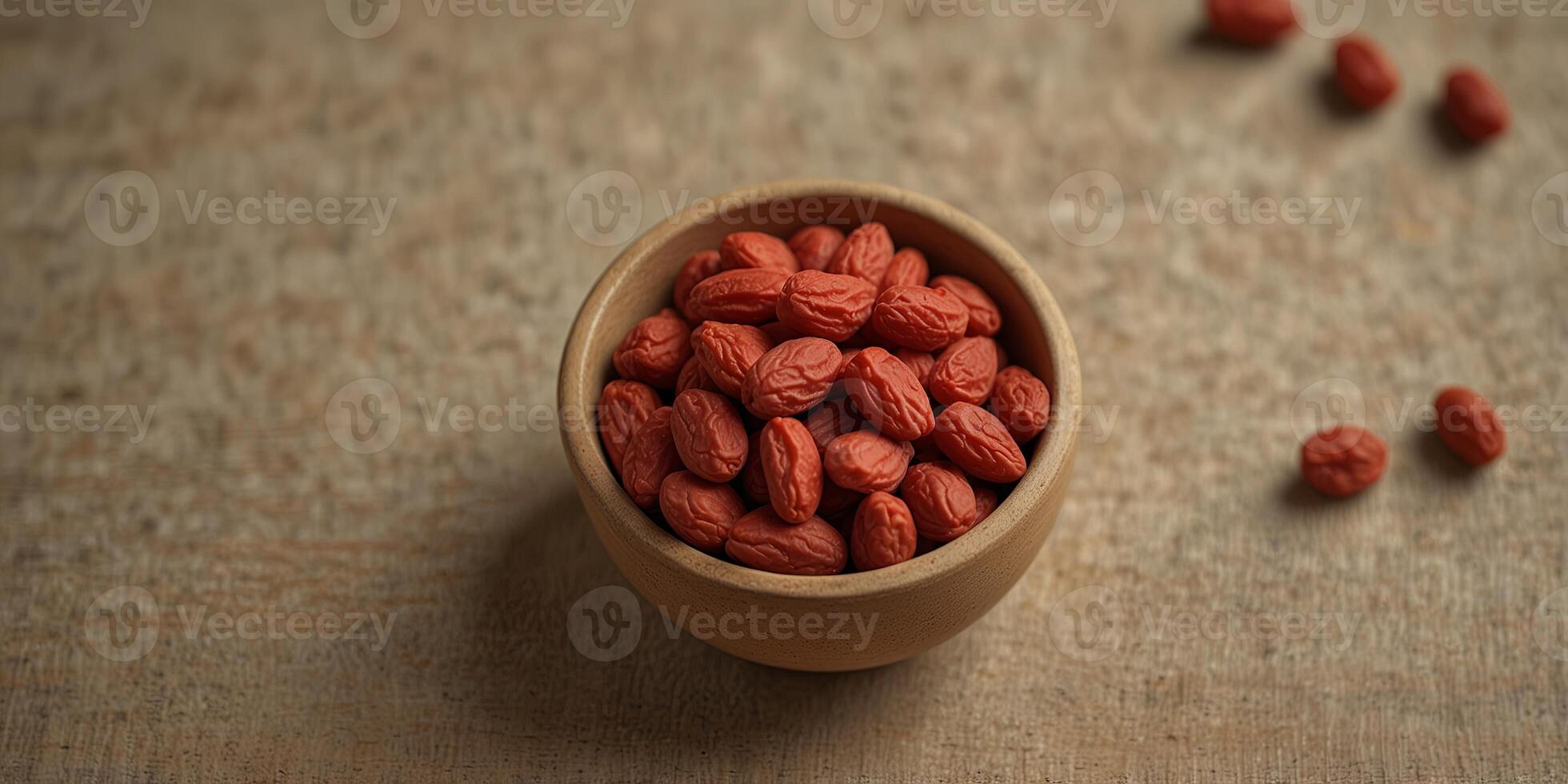 Dried goji berries on a beige background, minimalistic top view Natural health and wellness concept. photo