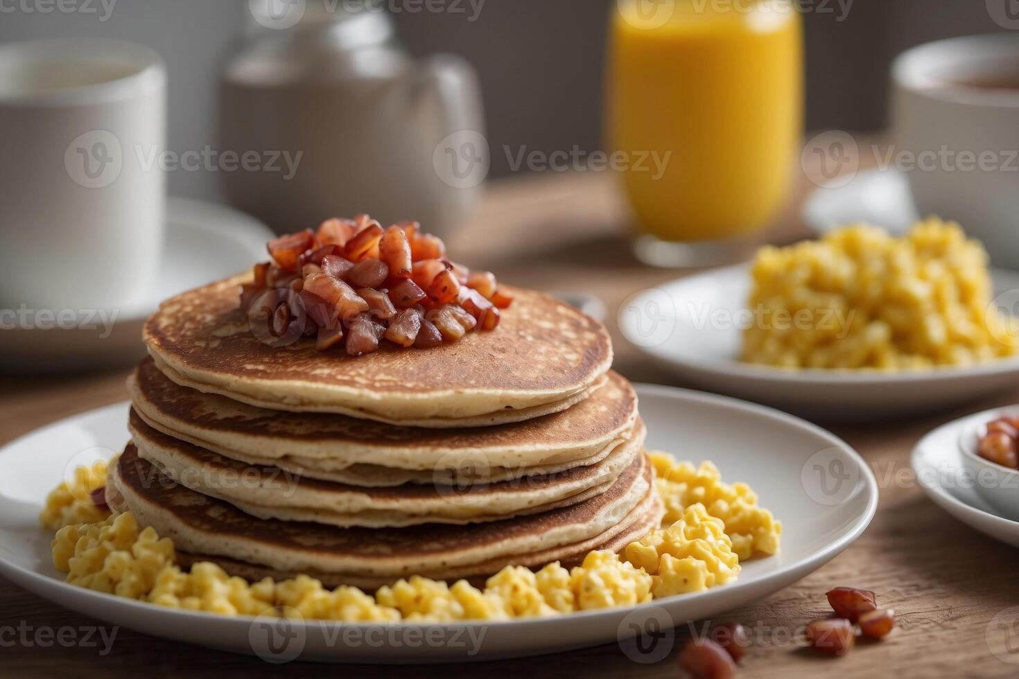 Buckwheat pancakes served with scrambled eggs and turkey bacon for a proteinpacked breakfast. photo