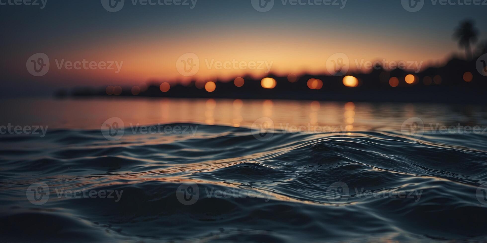 The tranquil waters of the ocean turn ominous as the darkness of night blankets the beach creating an unnerving contrast to the usually peaceful scene. photo