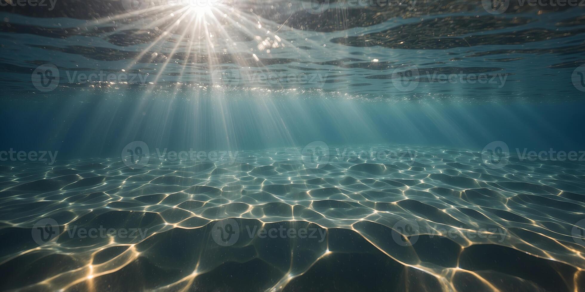 A shot from underneath the water with rays of sunlight shining through the surface of a solarpowered pool. photo