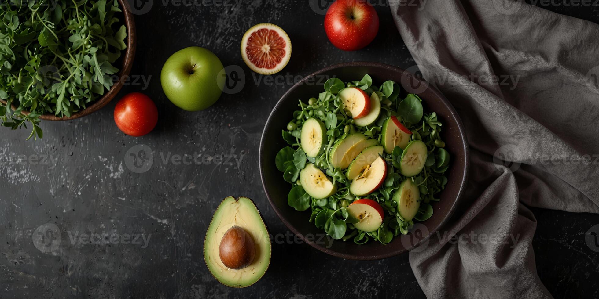 Healthy salad with avocado pea greens and apple on dark stone surface Organic food idea top view flat lay. photo
