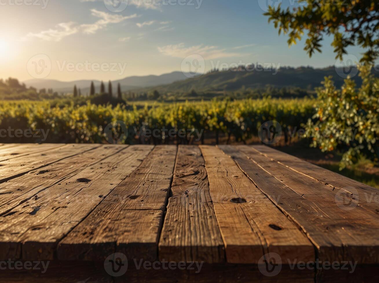 empty wooden table with a perspective of the early morning sun over a tuscan vineyard. photo