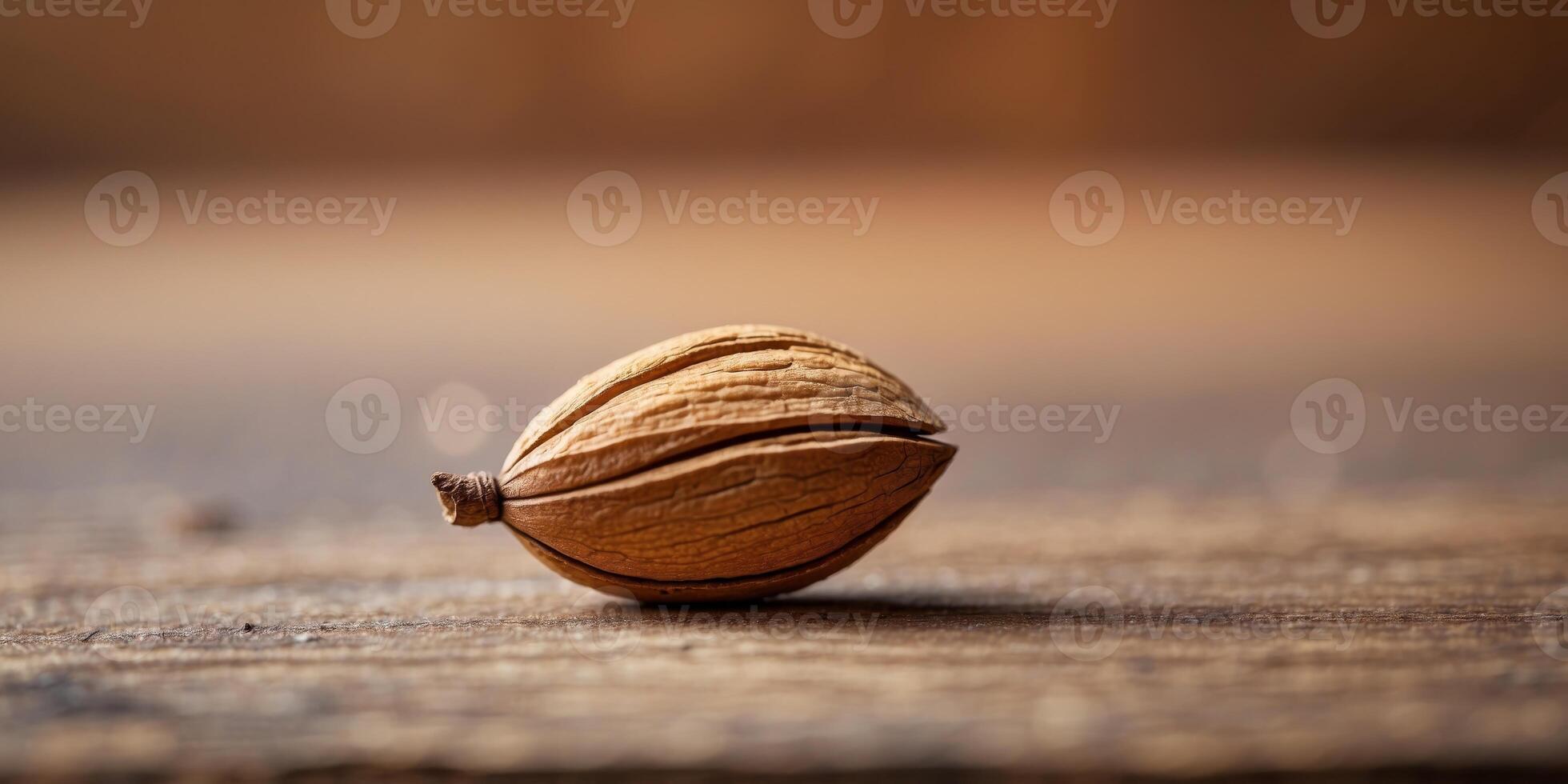 Macro Shot of Solitary Almond on Rustic Wooden Surface with Blurred Background. photo