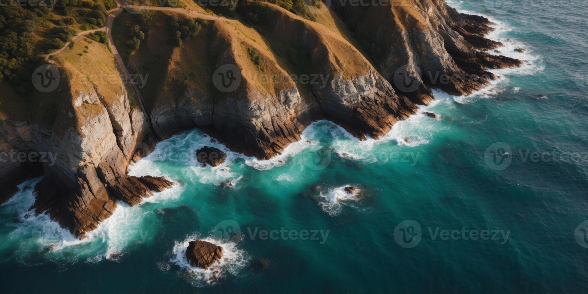 Aerial view of the ocean meeting the rocky coastline. photo