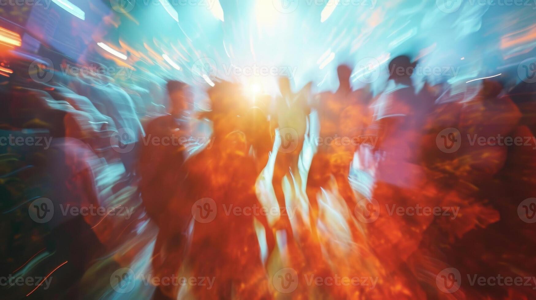Blurred figures sway and jump in a mesmerizing display of energy and excitement representing the euphoric state of a concert crowd photo