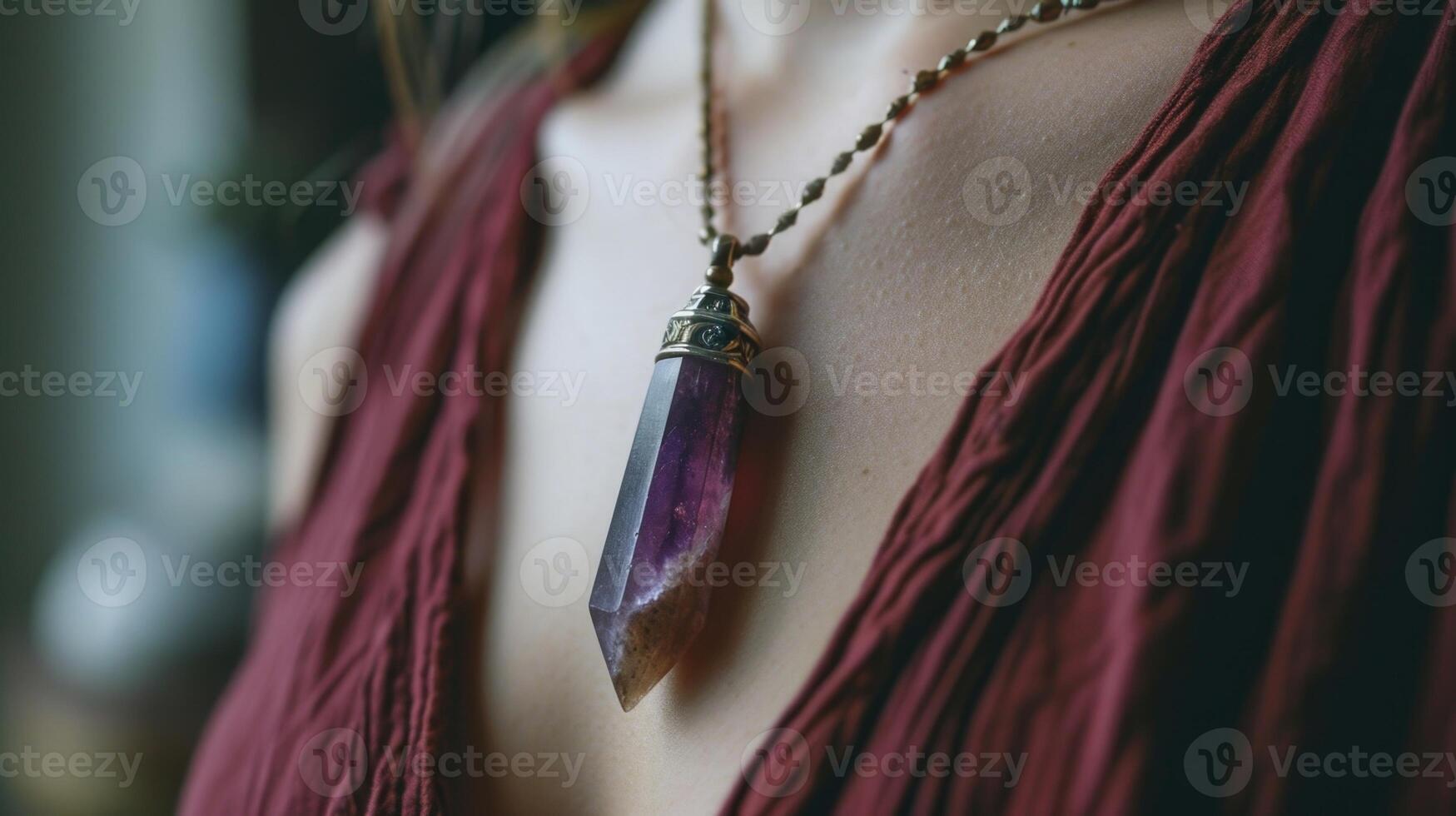 A person wears a crystal pendant, believing in its ability to enhance their meditative state and promote healing. photo