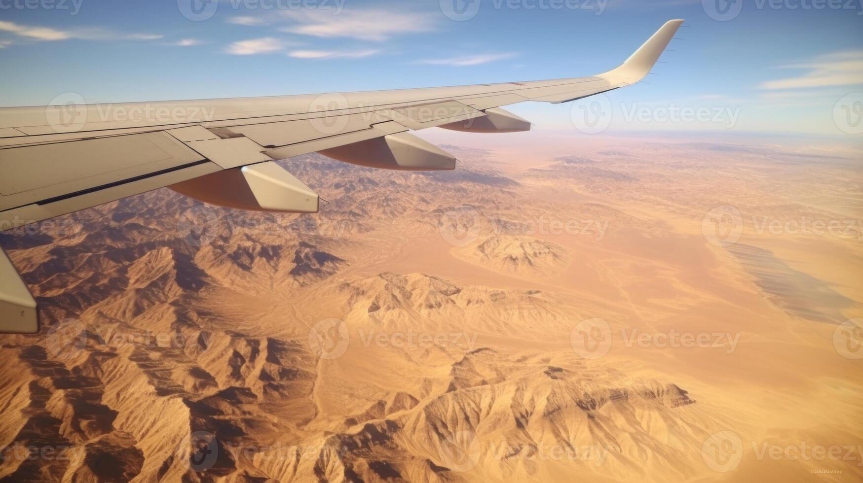 Flying over the desert, the natural beauty of the landscape is amplified from above. Crisp, golden sands stretch out in every direction, giving way to stunning rock formations that seem photo