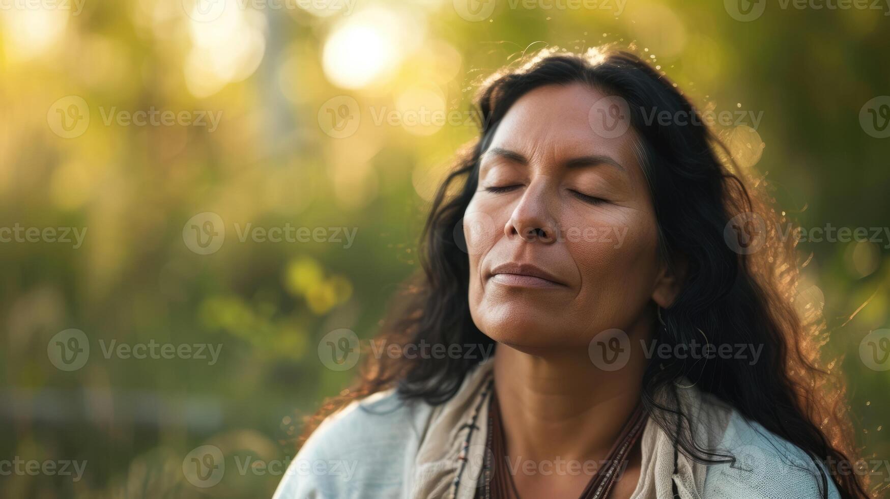 A woman of Native American descent sitting in a peaceful setting her eyes closed as she practices mindfulness techniques to cope with her fertility challenges photo