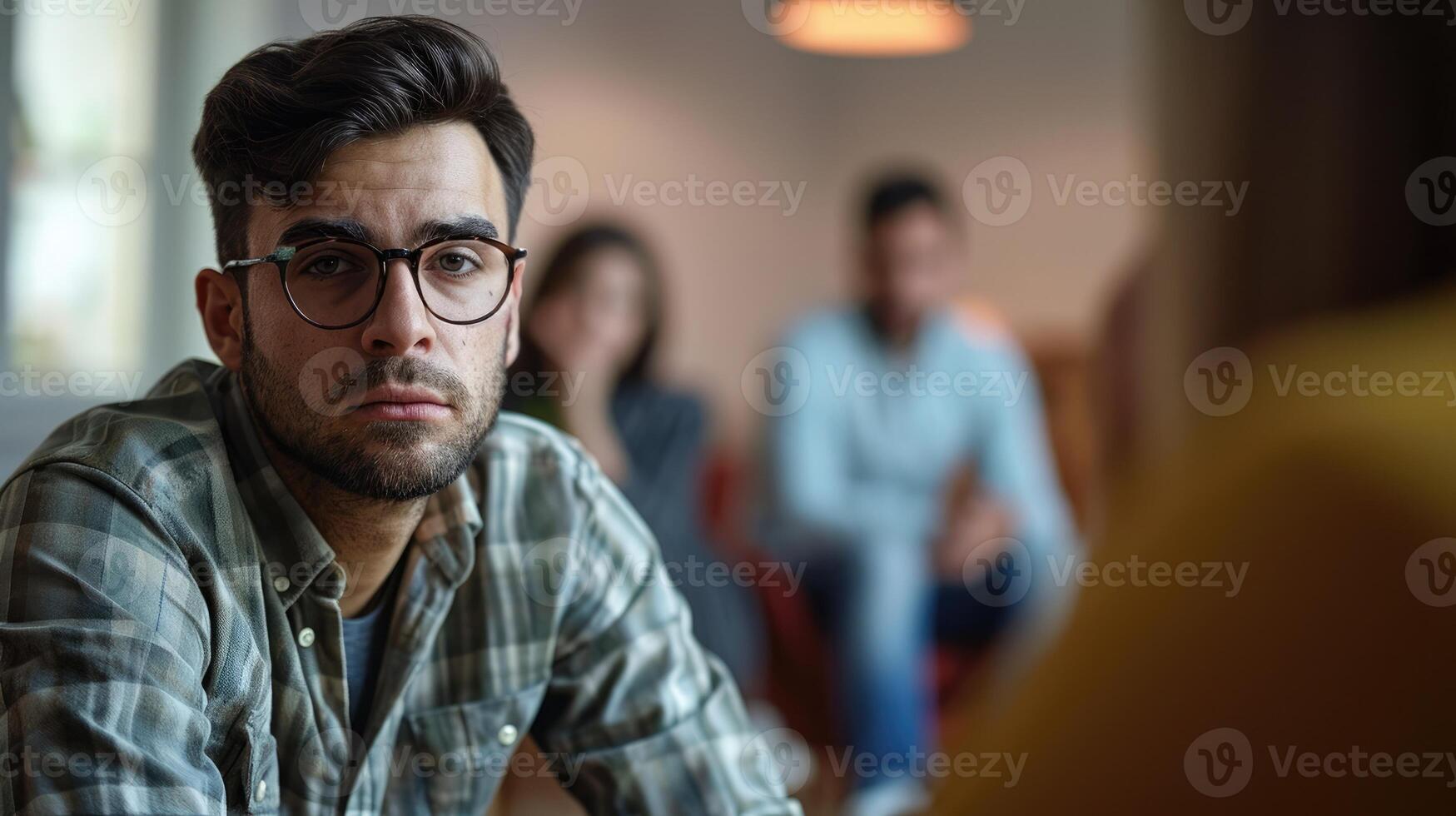 A man looks enviously at his friends successful career wondering why he hasnt achieved the same photo