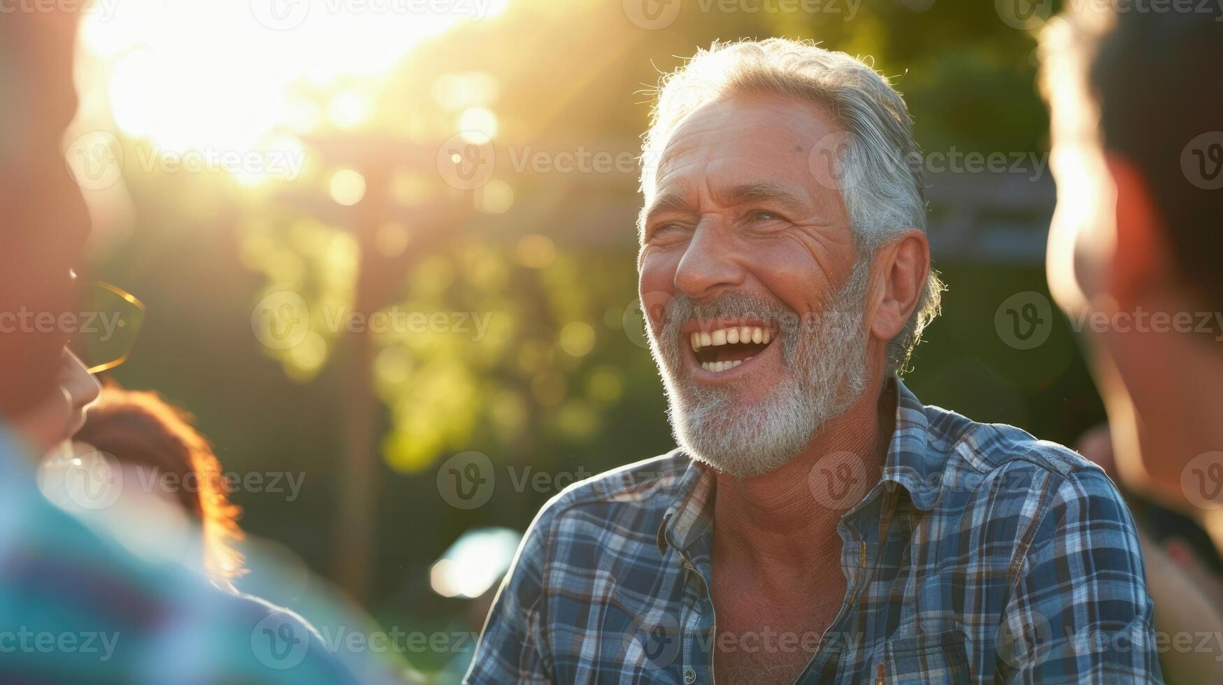 A middleaged man laughing with friends at a BBQ enjoying the simple s in life photo