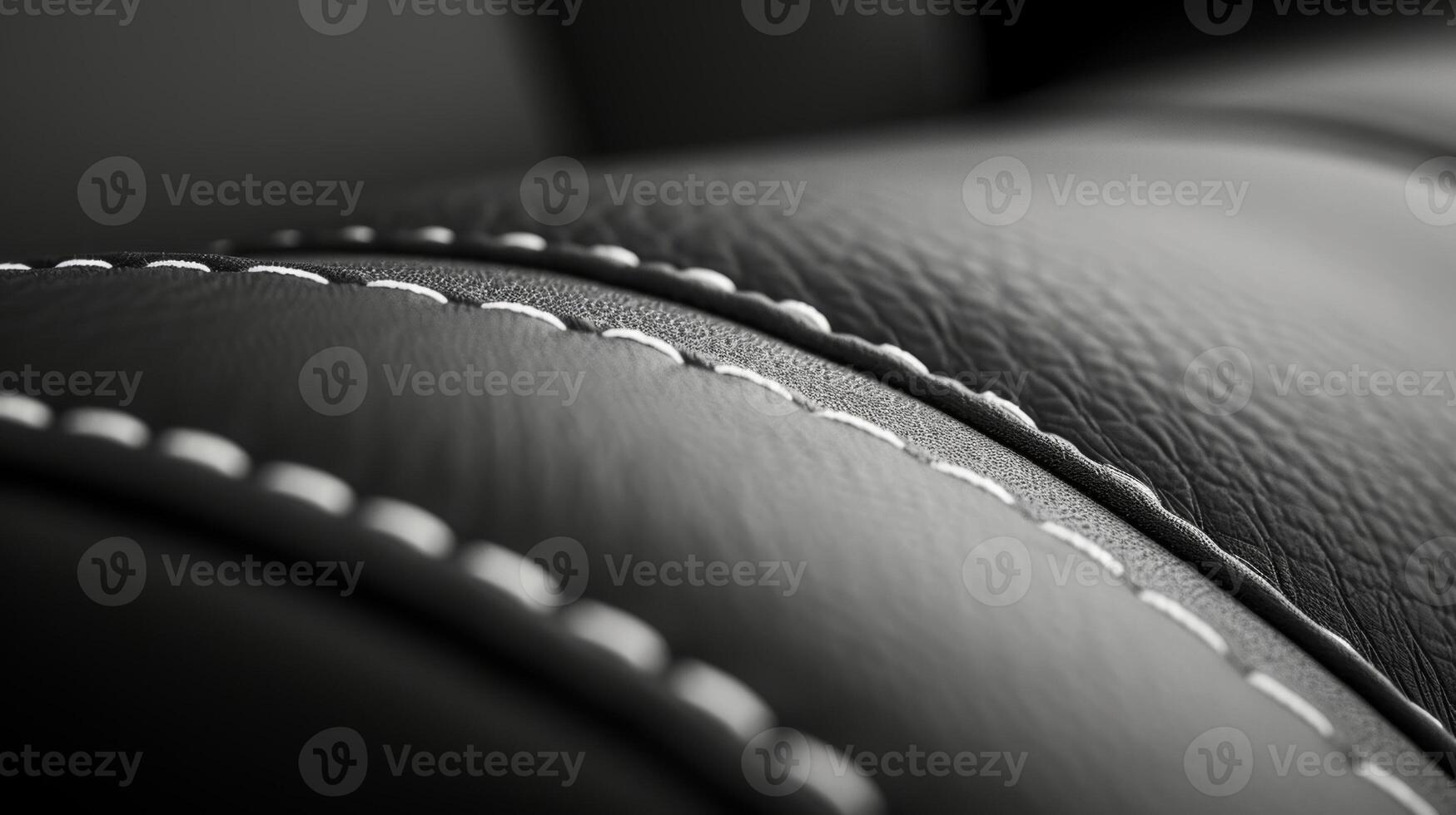 A closeup shot captures the contrast stitching on the seat with a bold white thread creating a striking outline around the edges of the dark leather fabric photo