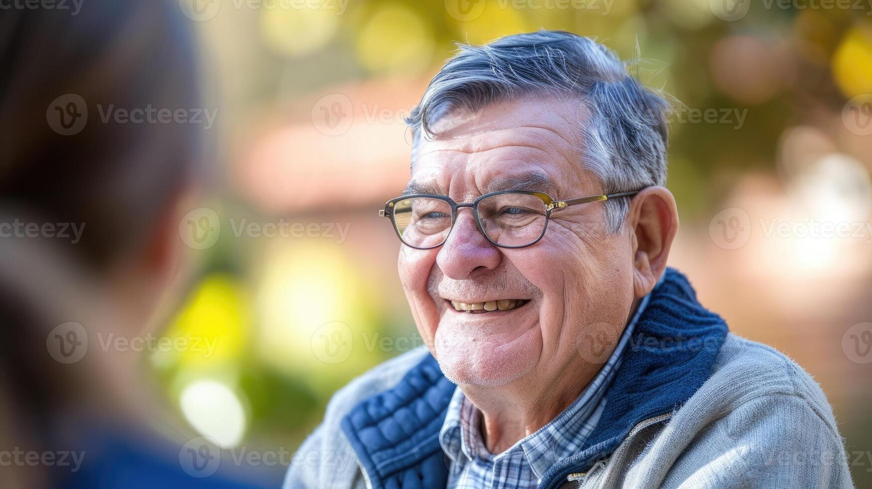 A middleaged man with autism a broad smile on his face as he engages in a conversation with his the photo