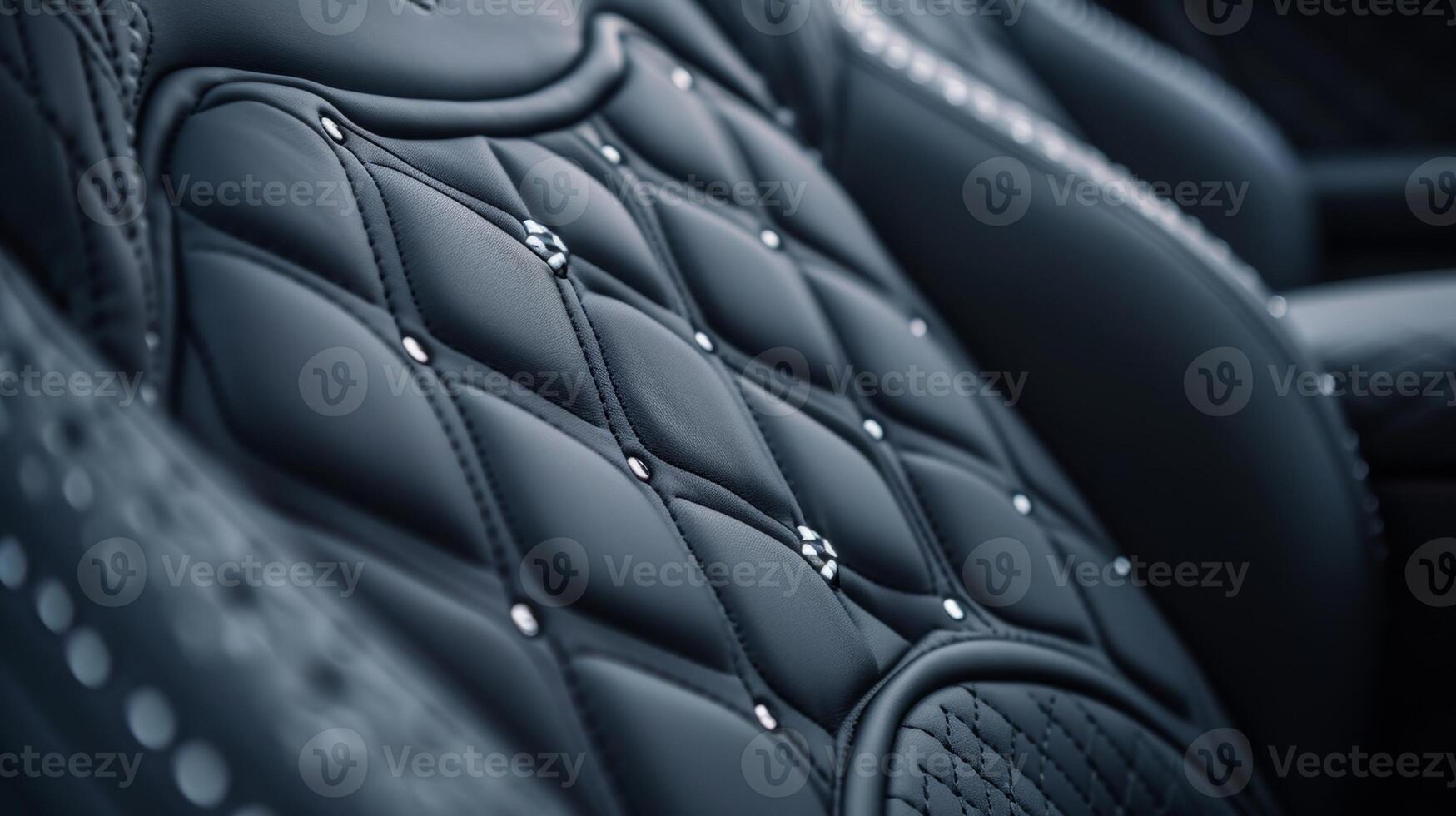 The camera slowly pans over the seat stitching revealing a gorgeous pattern of interlocking diamonds and circles in varying shades of grey showcasing the expert craftsmanshi photo