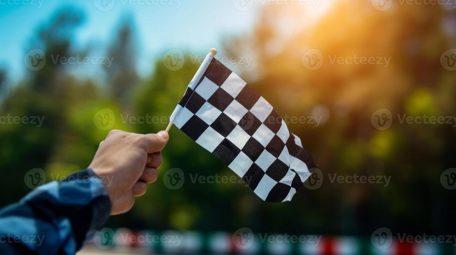 The checkered flag being ped from one hand to the other by the race winner a symbolic gesture of their victory and the start of a new journey as a champion photo