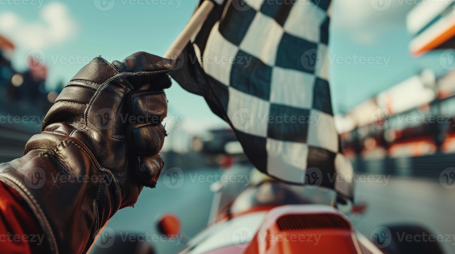 A tight closeup of a pair of gloved hands grasping a checkered flag as an intense race takes place in the background capturing the adrenalinefueled atmosphere of vintage racing photo