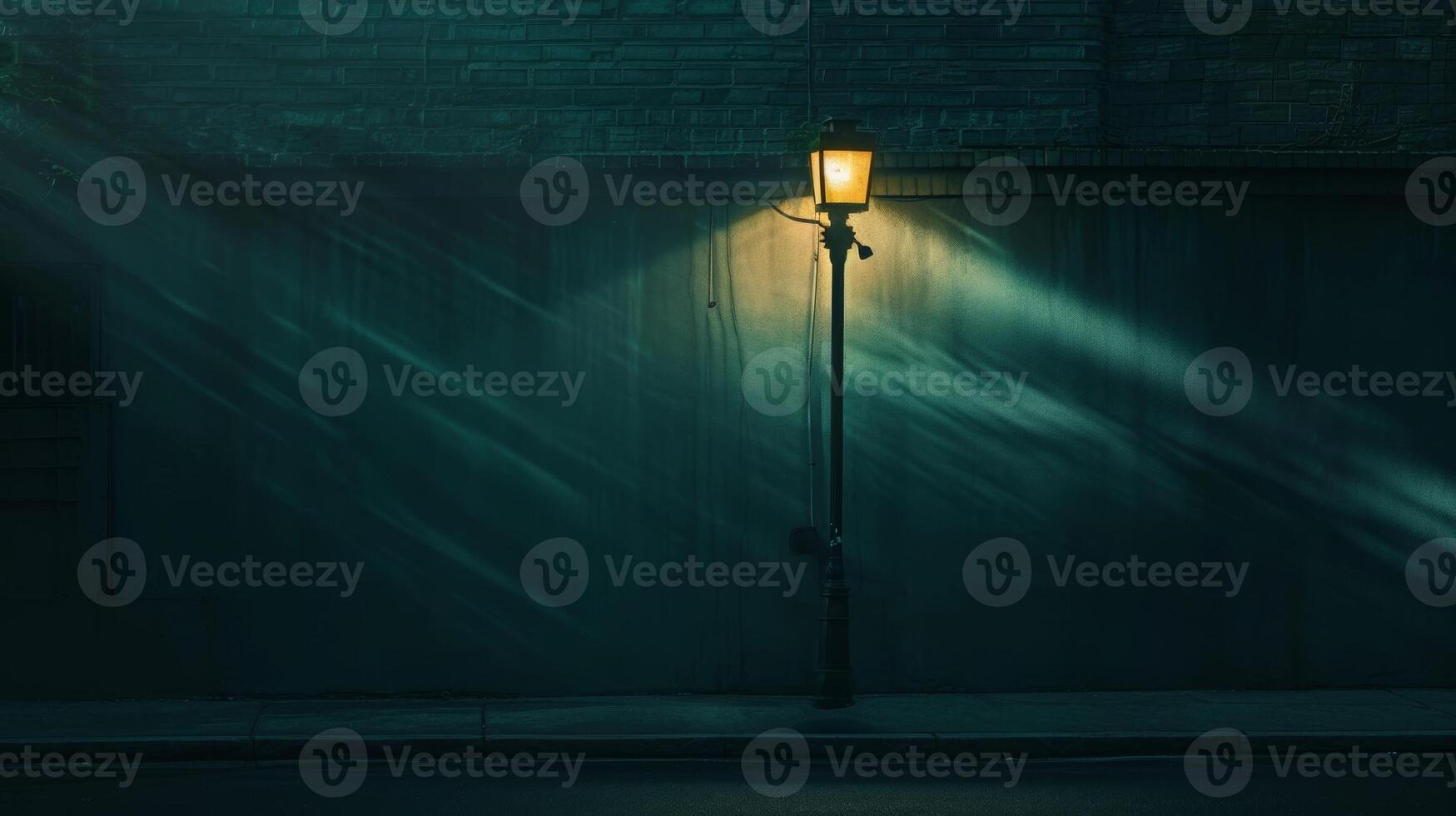 The soft glow of a lamp post its light spilling onto a deserted street creating a play of shadows that adds depth and dimension to the scene photo