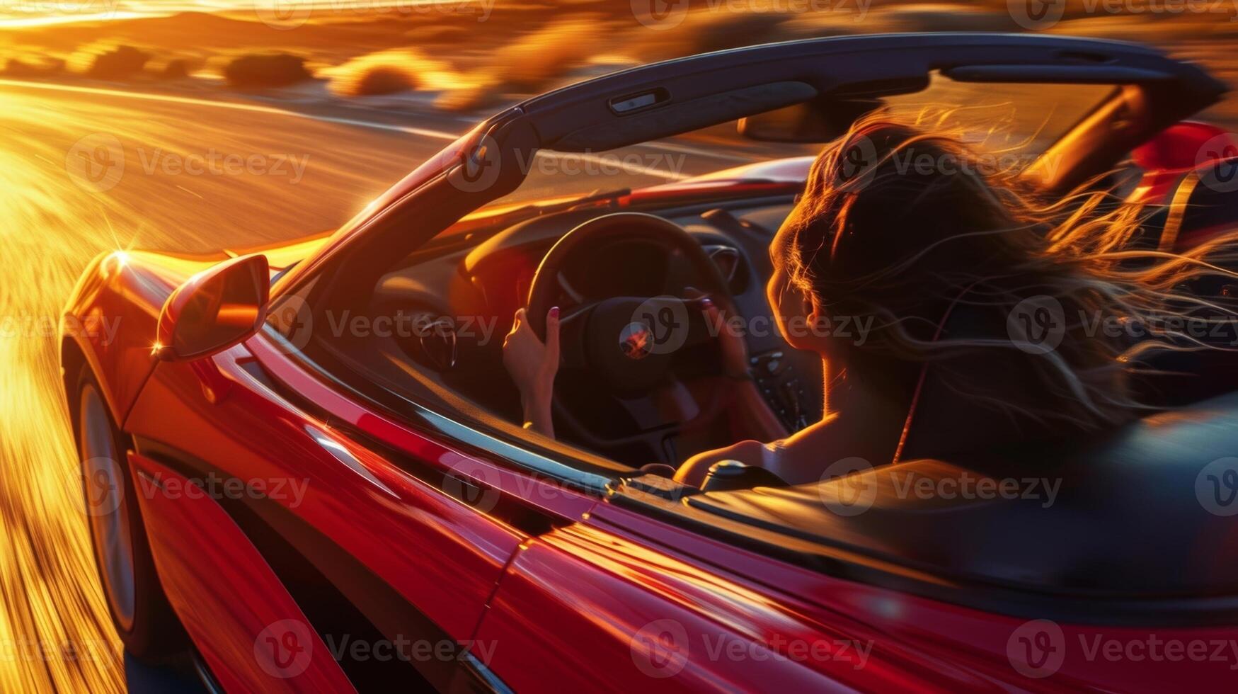 A closeup of the drivers face as the convertible top is lowered capturing the feeling of the wind rushing through their hair and across their skin photo