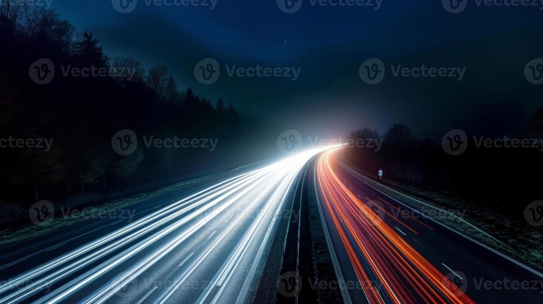 The normally mundane highway is transformed into a magical spectacle of light as cars create long exposure streaks against the dark background photo