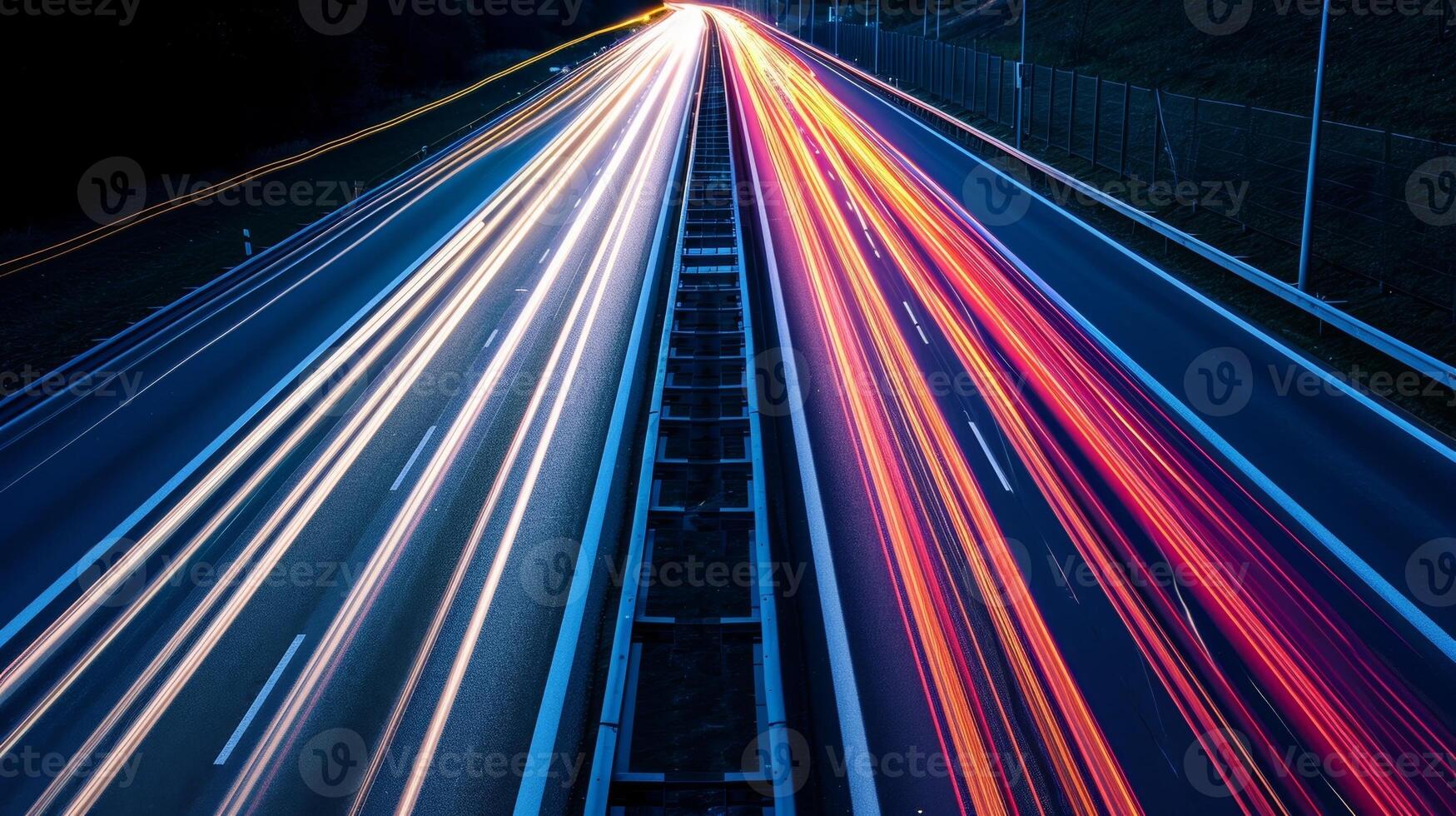 A closeup of the highway shows the intricate patterns created by the light streaks of vehicles ping by in a long exposure shot photo