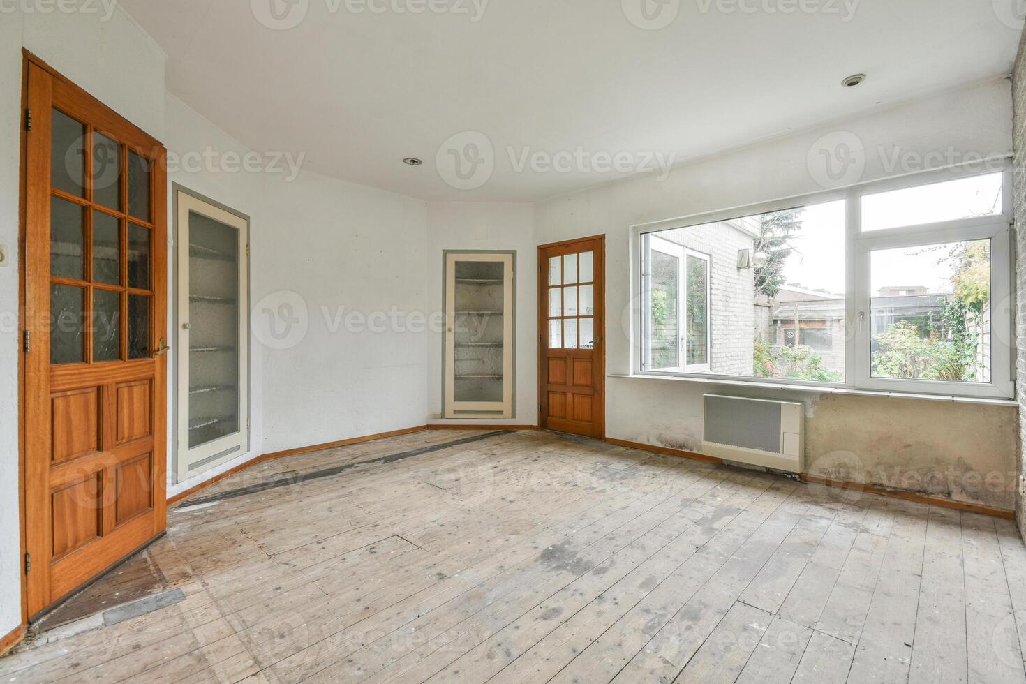 Empty room with wooden floors and windows photo