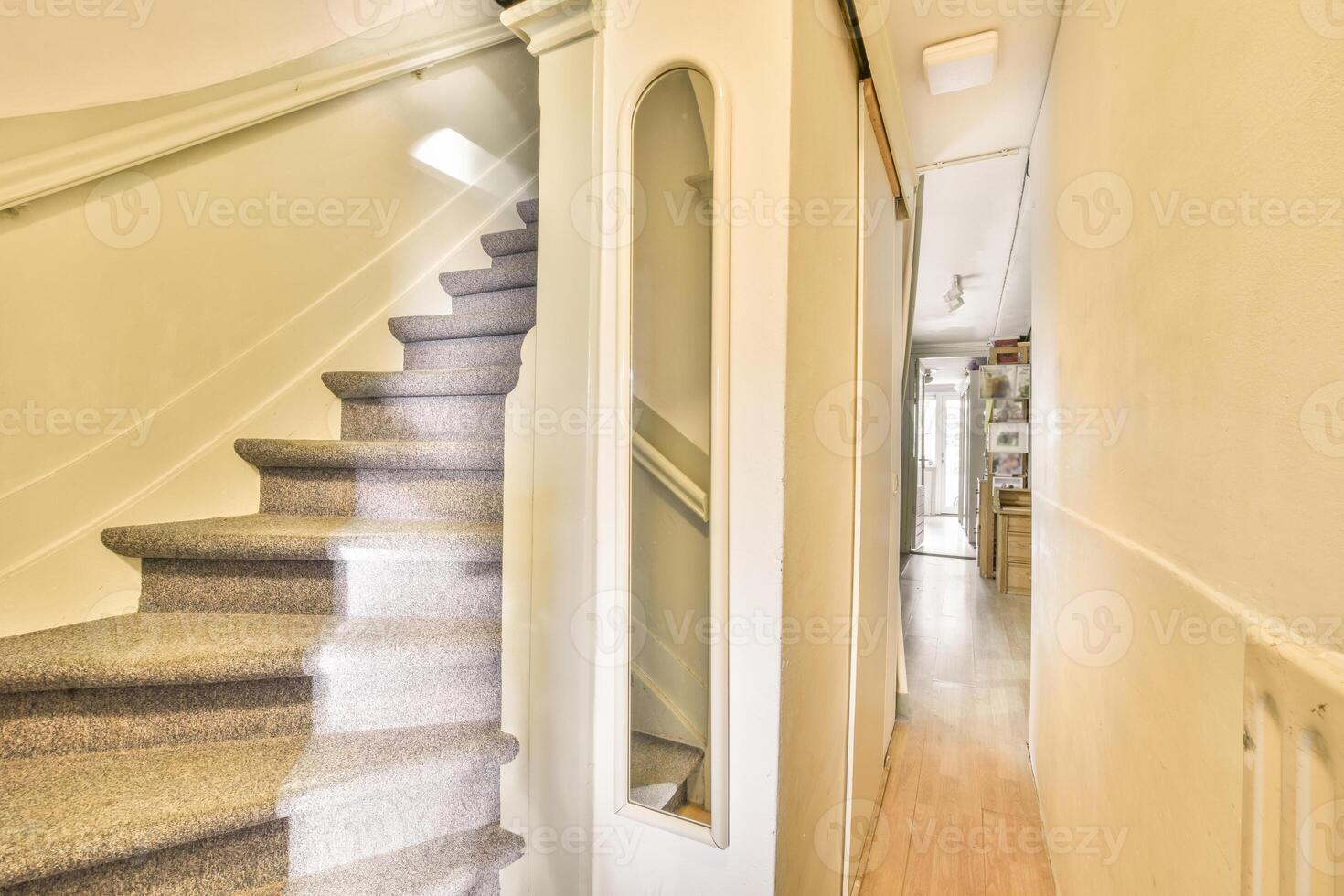 A stairway with a mirror on the wall photo