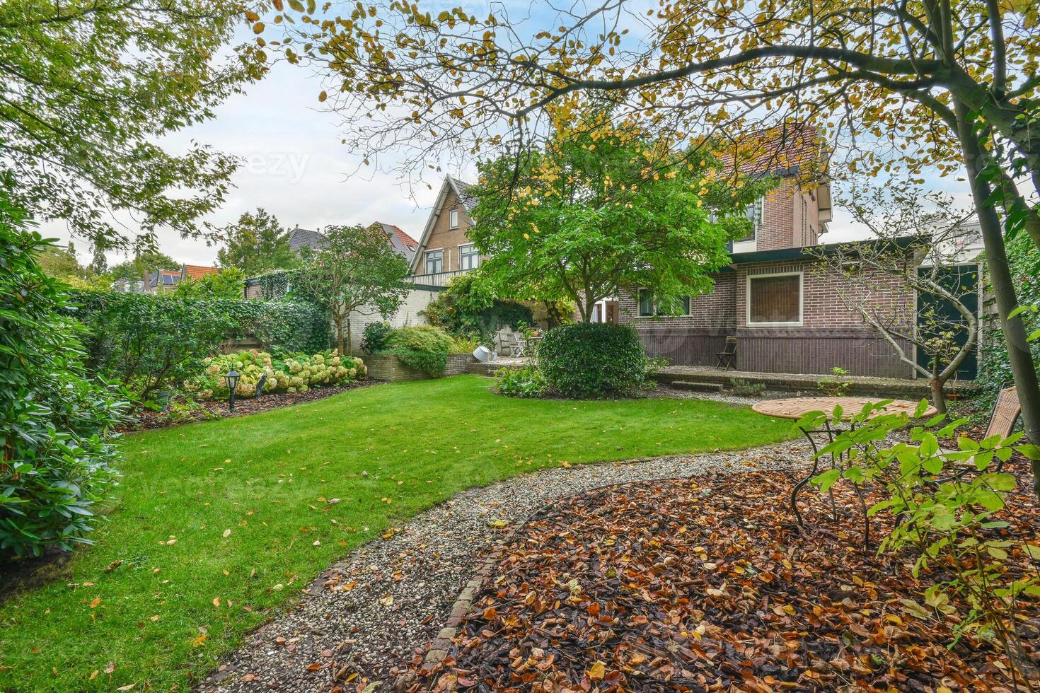 A garden with trees and bushes in the foreground photo