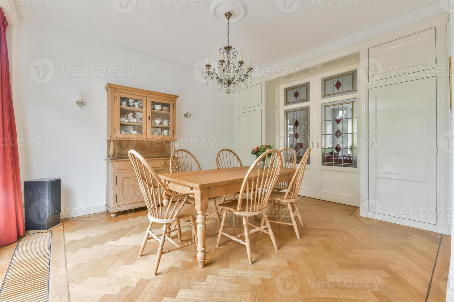 A dining room with a table and chairs photo