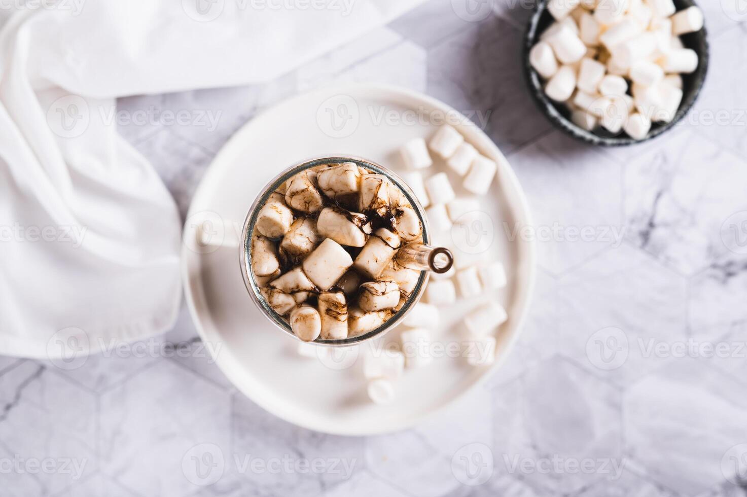 Trendy drink of cola and marshmallow in a glass on the table top view photo