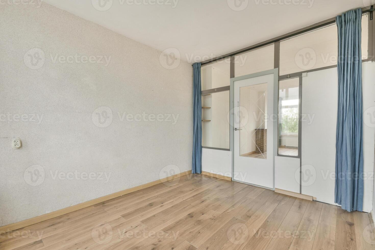 An empty room with wooden floors and a sliding door photo