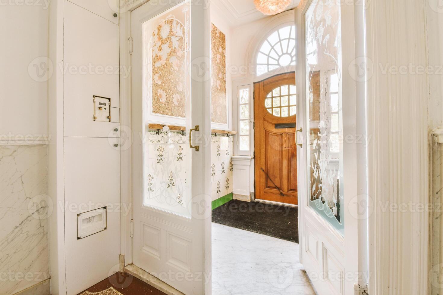 A hallway with a door and a window photo