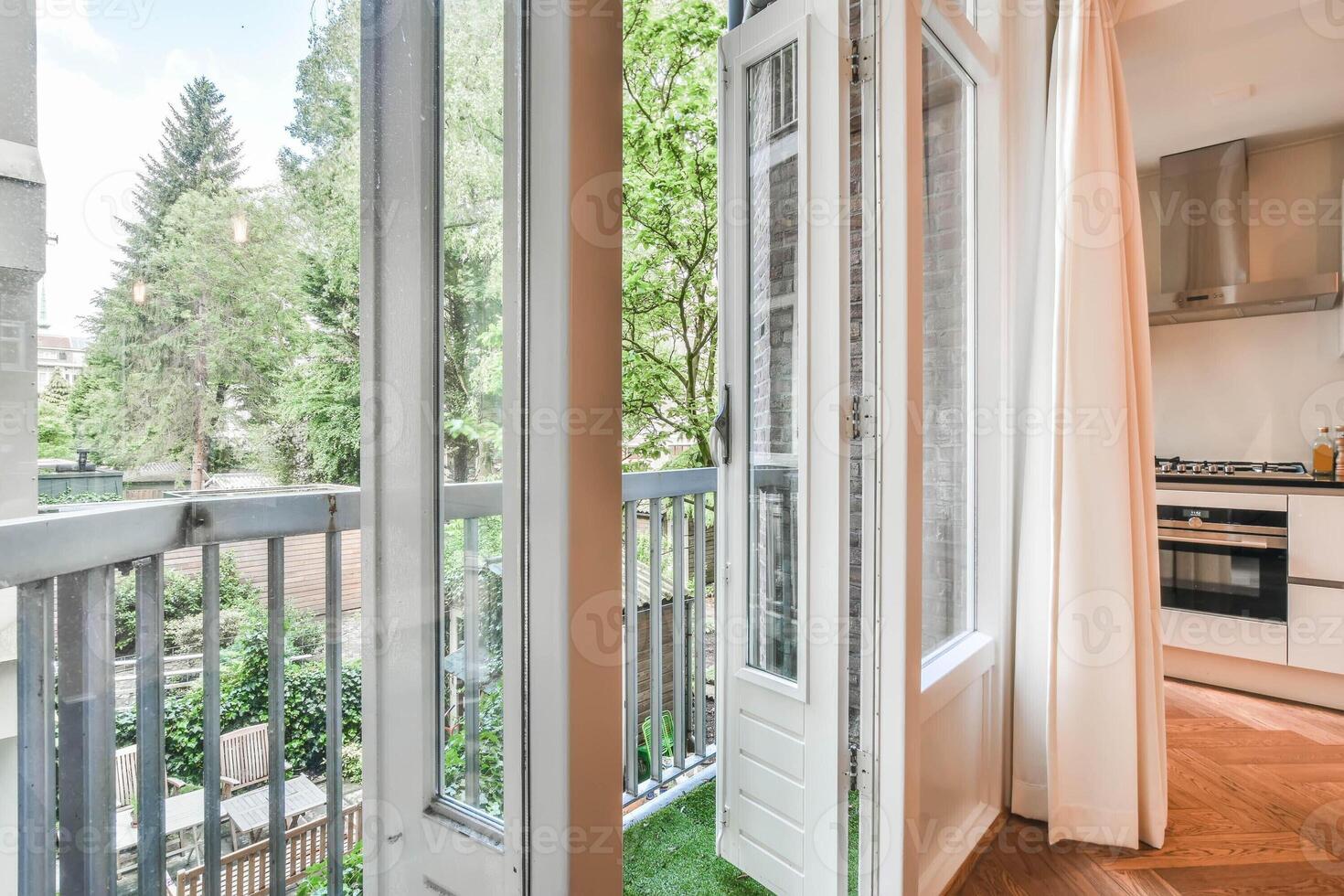A kitchen with a window and a balcony photo