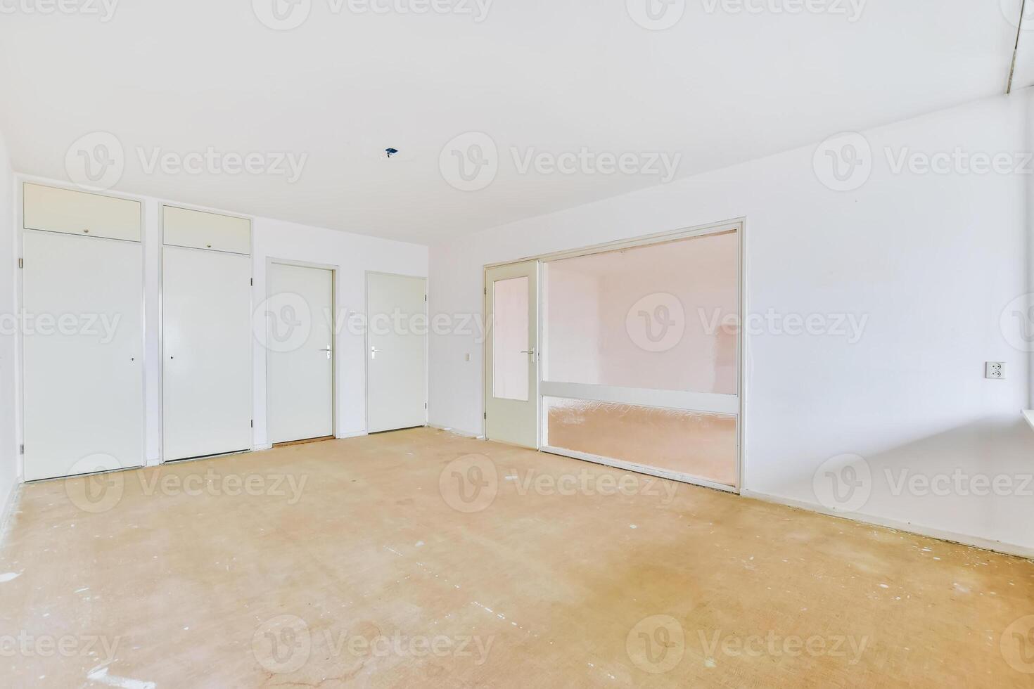 Empty room with white walls and wooden floors photo