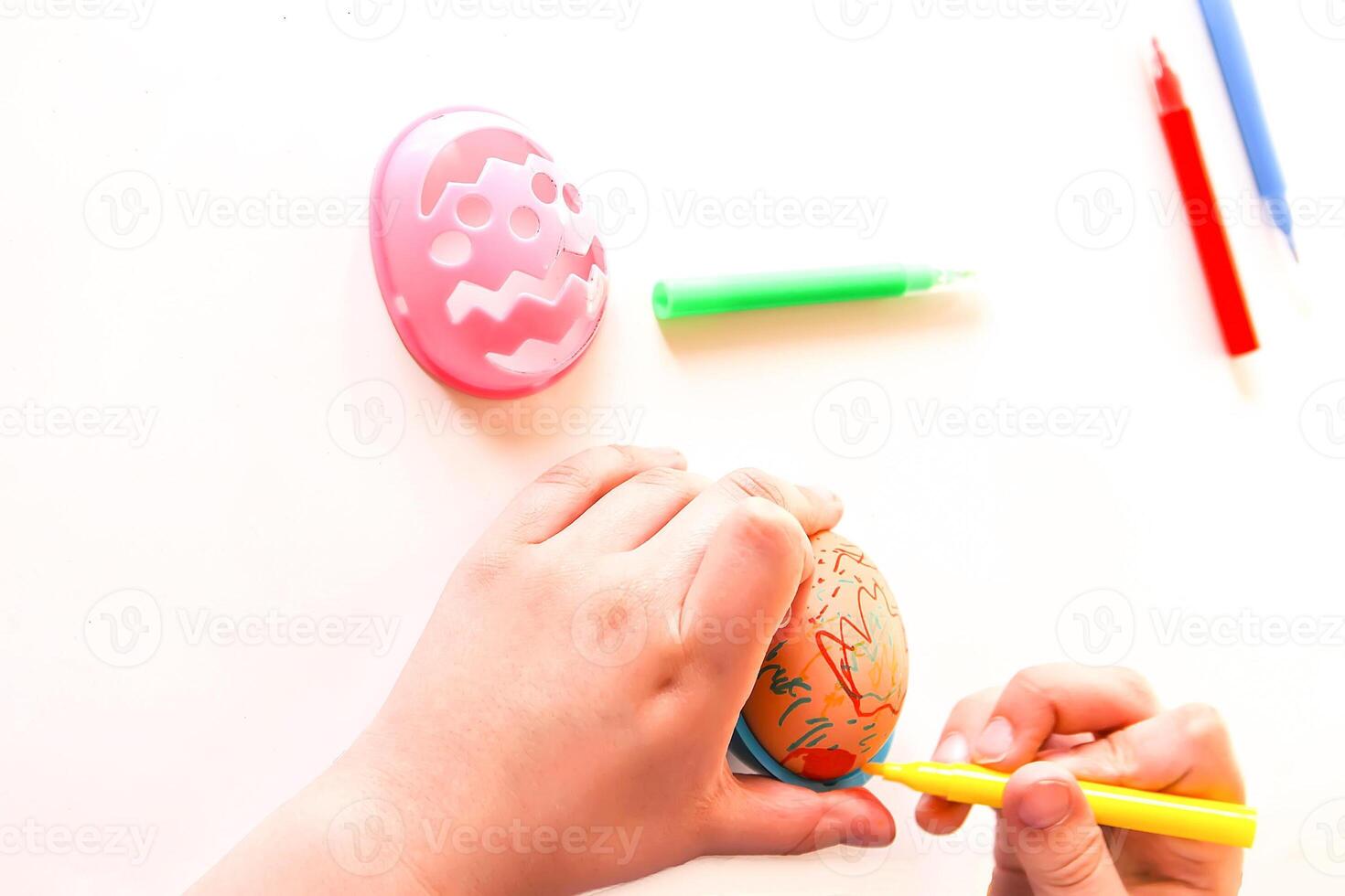 Child decorate Easter eggs photo