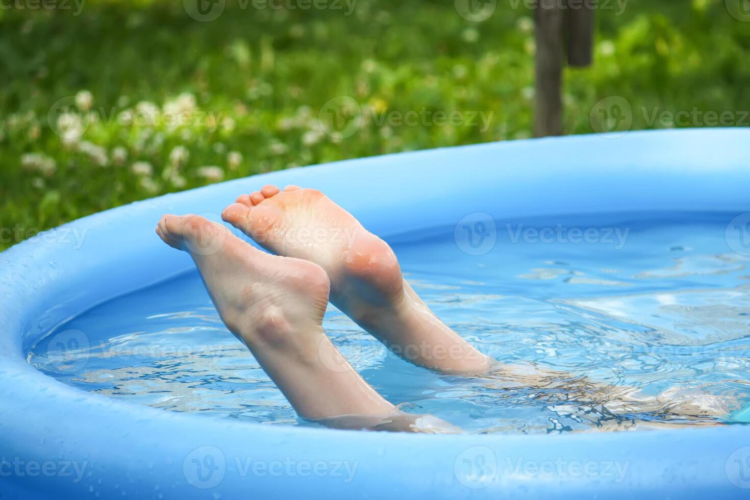 Little girl playing in swimming pool outdoors at summer. photo