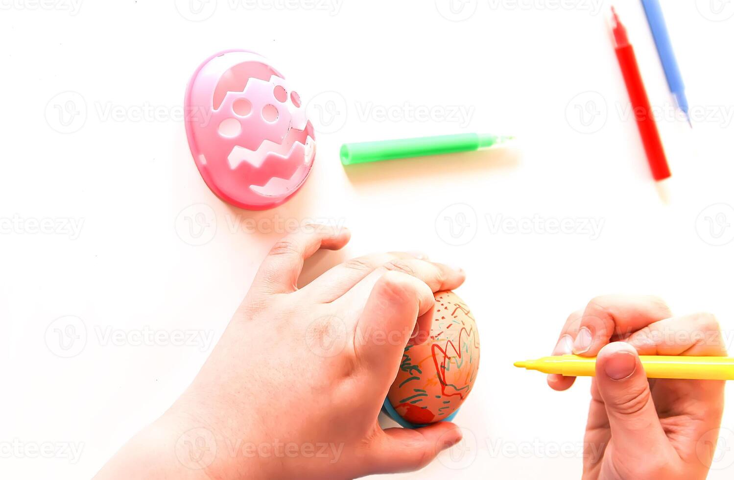 Child decorate Easter eggs photo
