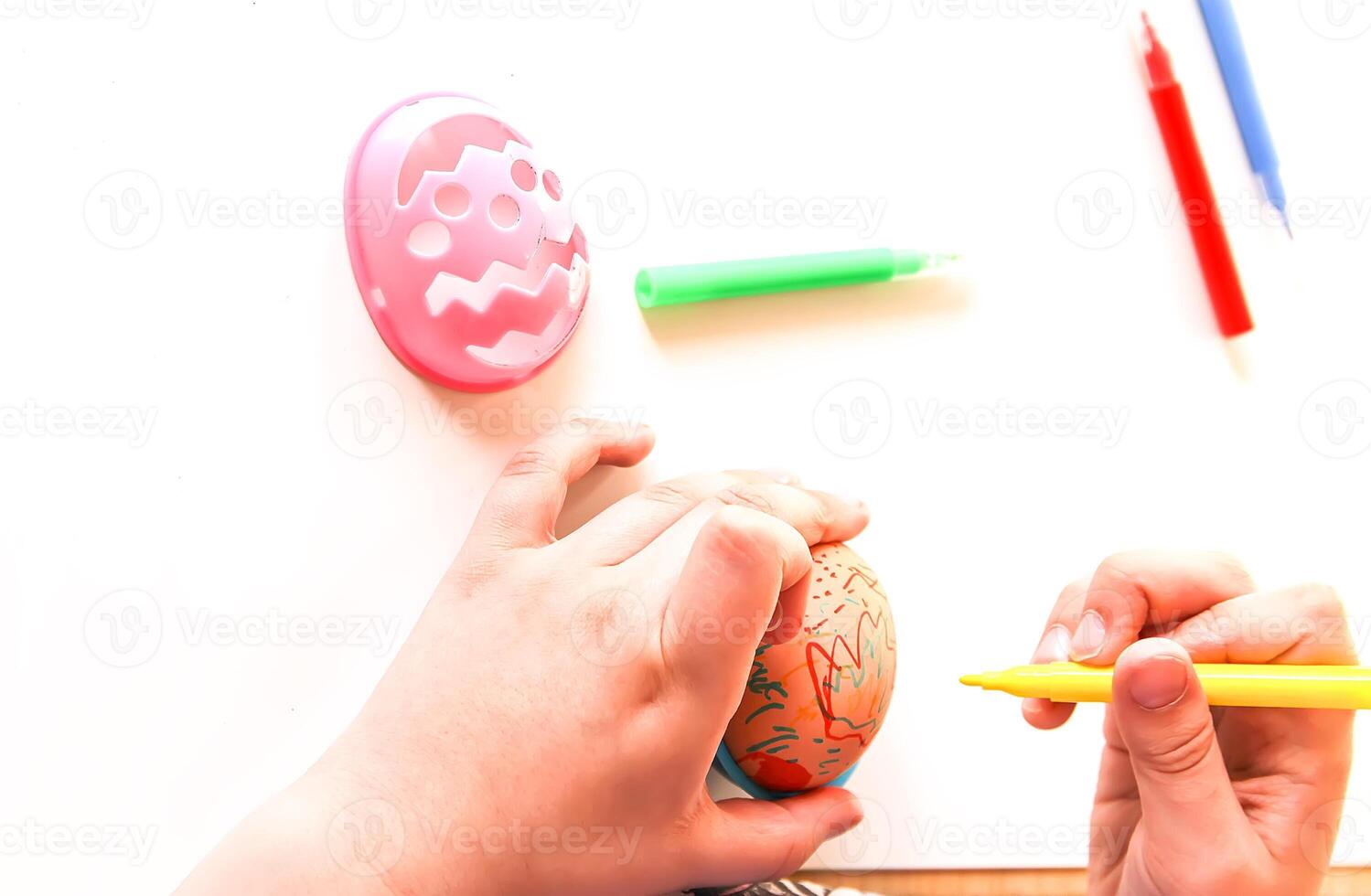 Child decorate Easter eggs photo