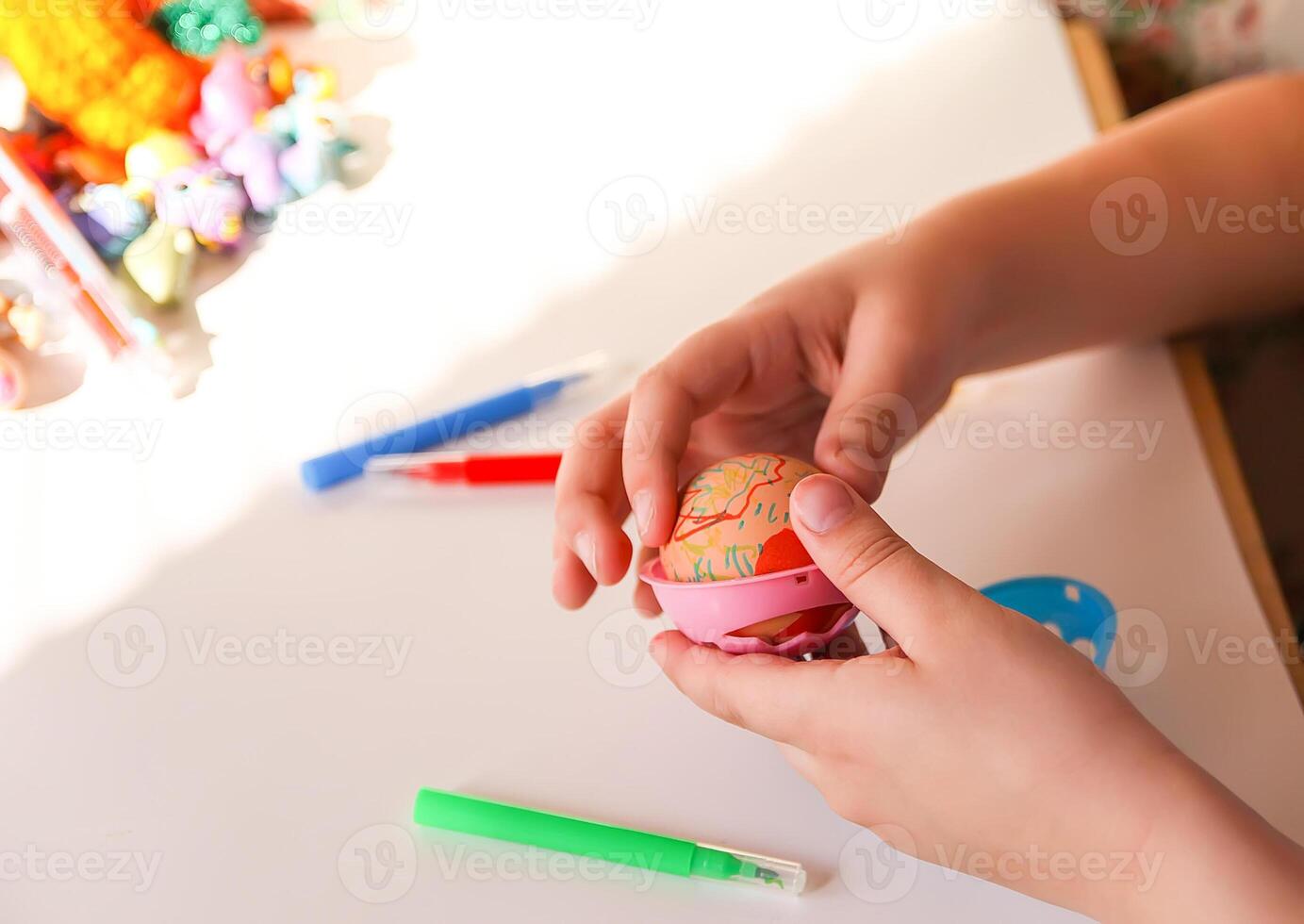 Child decorate Easter eggs photo