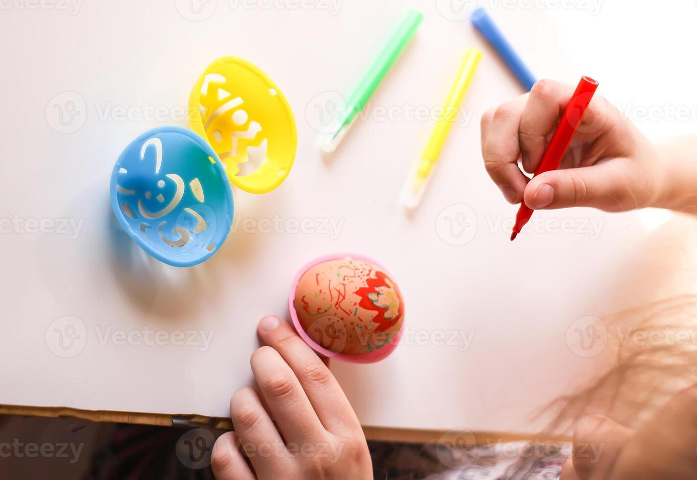 Child decorate Easter eggs photo