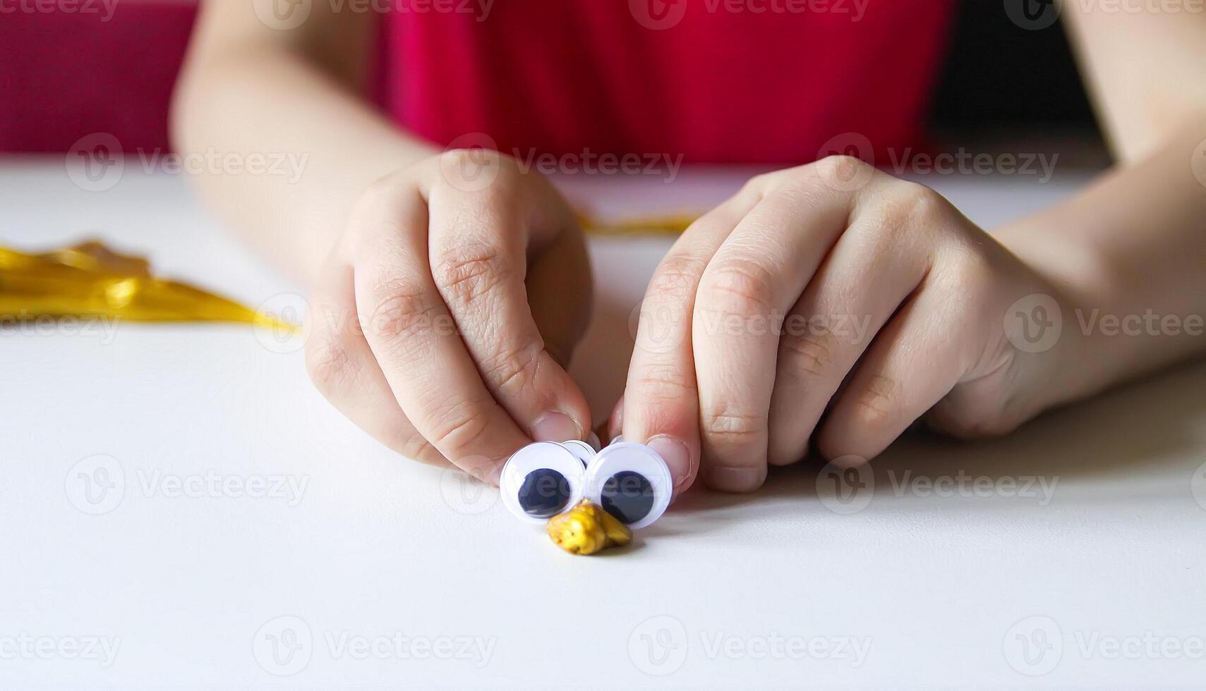 Child playing with a gold slime photo