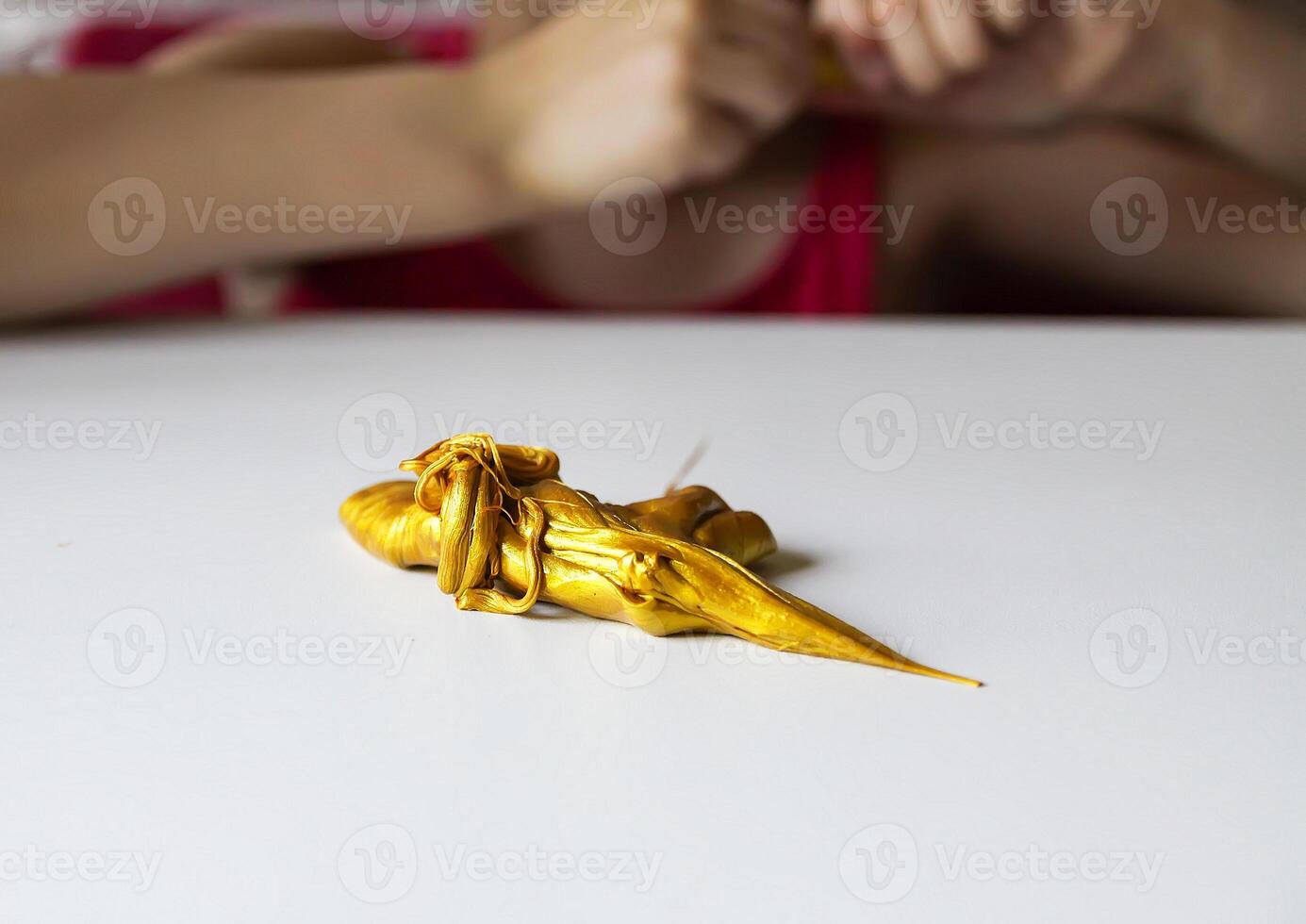 Child playing with a gold slime photo