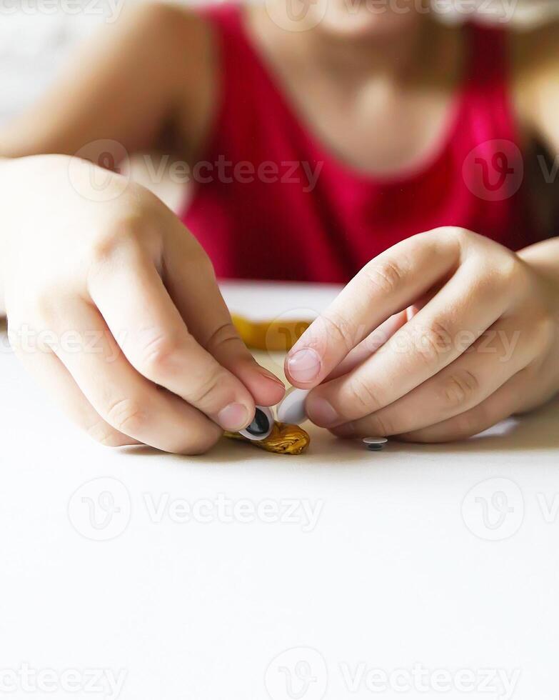 Child playing with a gold slime photo