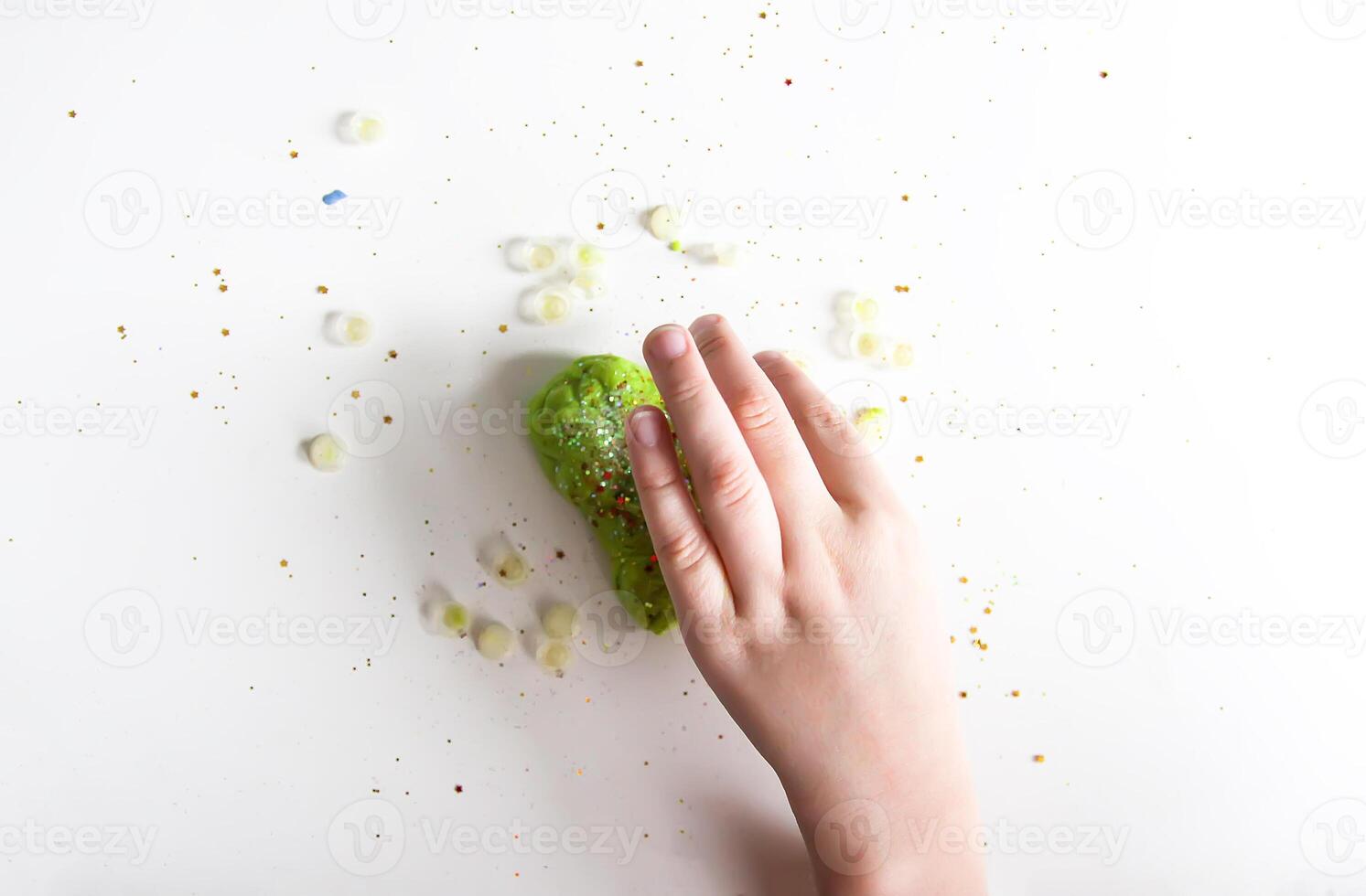 Green heart with shiny glitters made from slime photo