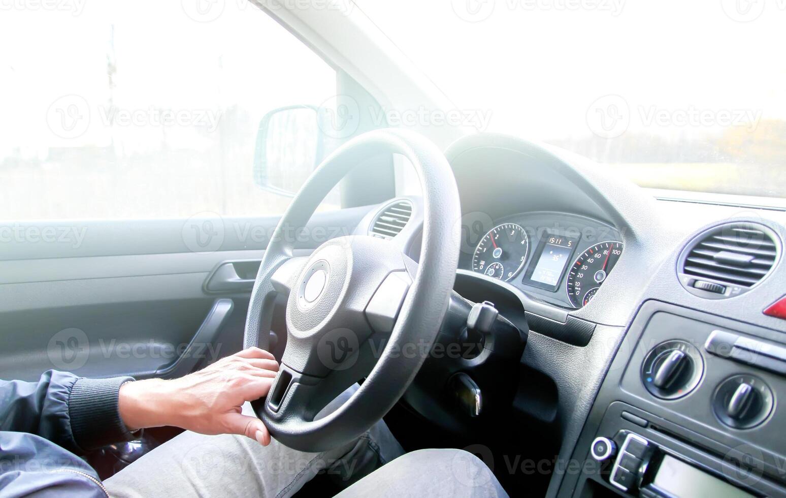 Man drives acar. View through the moving car windscreen. photo