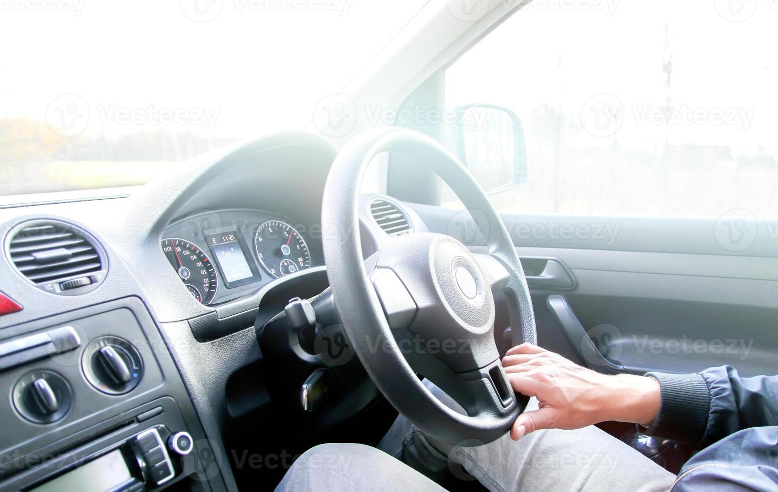 Man drives acar. View through the moving car windscreen. photo