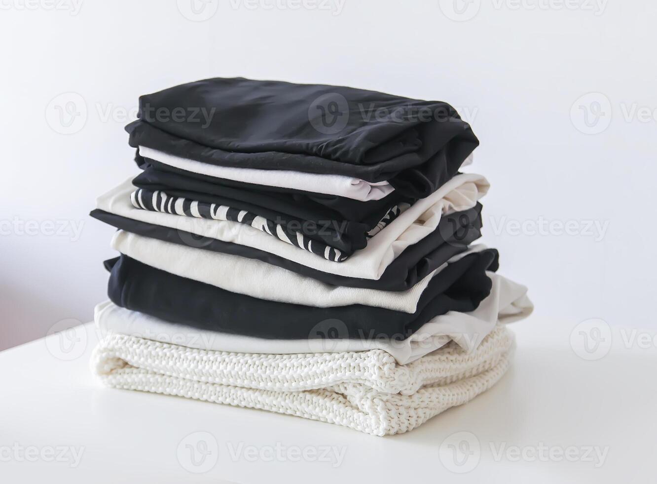 Stack of folded colorful clothes. Compact storage organizing photo